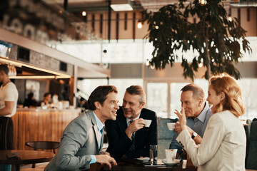 Business people having a meeting at an indoor cafe