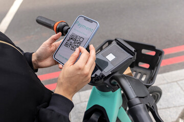 close up woman's hands paying with the mobile phone through an app