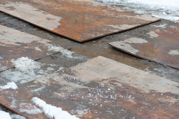 plywood sheets on the ground at the entrance of a construction site