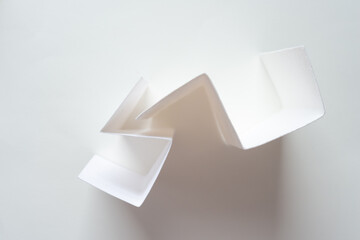 folded paper with triangle edges standing upright on blank paper