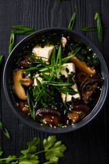 Japanese food. Miso soup. on a black wooden background.