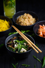 Japanese food. Miso soup. on a black wooden background.