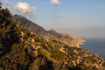 Rocky coast with steep mountains at the wild romantic coastal village of Karkinagri, Ikaria island,...