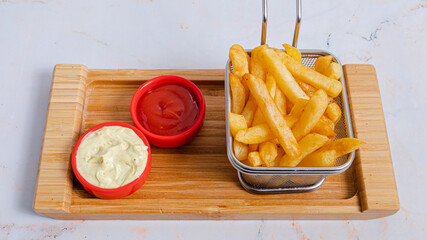 French fries basket with mayonnaise and ketchup 