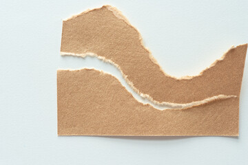 brown paper with torn elements on blank paper