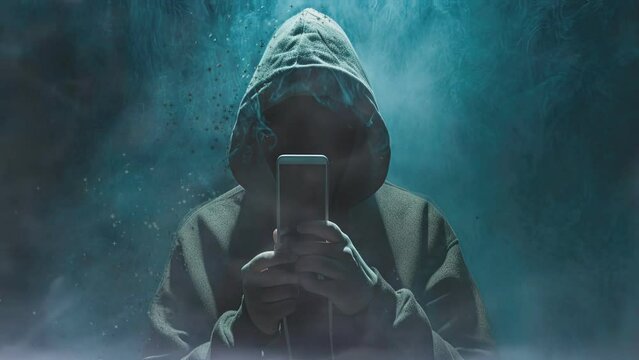 A symbol of cybersecurity threats, a hooded figure represents the elusive nature of computer hackers