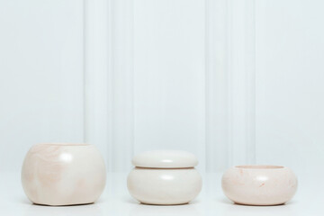 three ceramic candlesticks on a white table on a white 