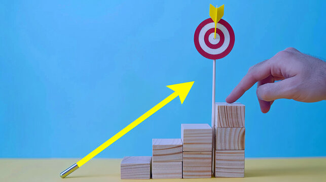 A conceptual image depicting success, with a finger pointing to a bullseye on a target that's placed atop a stair-like arrangement of wooden blocks. AI generated.