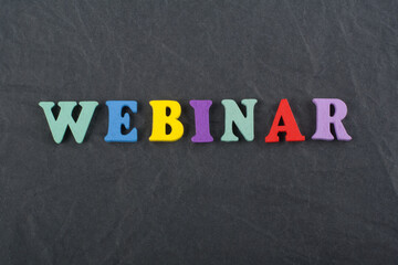 WEBINAR word on black board background composed from colorful abc alphabet block wooden letters,...