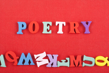 POETRY word on red background composed from colorful abc alphabet block wooden letters, copy space for ad text. Learning english concept.