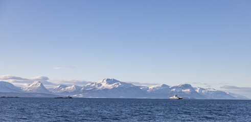 View of the mountains from the sea in Molde city area and a ferry 