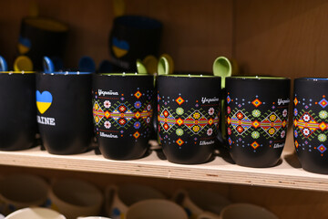 souvenir ceramic cups in a gift shop. translation: Ukraine