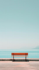 Fototapeta premium A red bench sits on the side of a road overlooking the ocean, providing a resting spot for passersby.