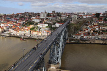 CITYSCAPE IMAGE OF PORTO, PORTUGAL WITH THE FAMOUS LUIS BRIDGE AND THE DOURO RIVER