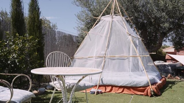 Chairs And Table With Teepee Bed At Yard During Sunny Day
