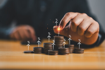 Businessman stacking coins money with up arrow and percentage symbol for financial banking increase...