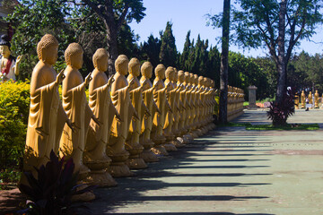 Yellow statues making hand gestures at the Chen Tien Buddhist temple in Foz do Igua&ccedil;u, Brazil