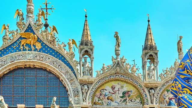 VENICE, ITALY - APRIL 25 2018: Detail of gable of Patriarchal Cathedral Basilica of Saint Mark showing patron apostle St. Mark with angels. Underneath is winged lion, symbol of saint and of Venice.