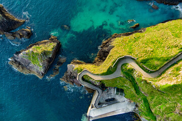 Dunquin or Dun Chaoin pier, Ireland's Sheep Highway. Aerial view of narrow pathway winding down to...