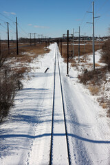 Straight rail track leading to the distance after snow in Wilmington, Delaware