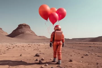 Crédence de cuisine en verre imprimé Couleur saumon Back view of Astronaut with red balloons in barren desert, ethereal landscape
