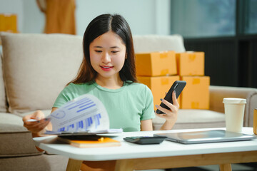 young Asian entrepreneur, the owner of a small clothing store, organizes online live streams...