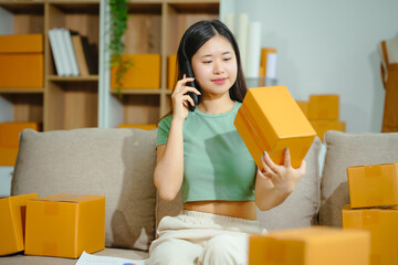 young Asian entrepreneur, the owner of a small clothing store, organizes online live streams...