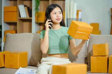 young Asian entrepreneur, the owner of a small clothing store, organizes online live streams...