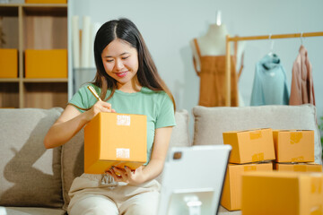 young Asian entrepreneur, the owner of a small clothing store, organizes online live streams...