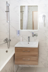 Mirror above the sink on a white wall in the bathroom