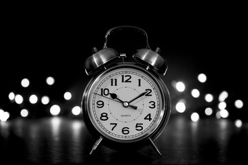 clock on black with bokeh light background