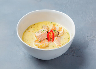 Milk soup with seafood in a plate.