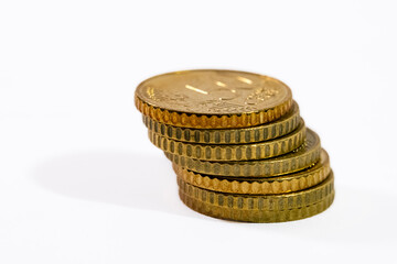 Stacked 50 euro cent coins on white surface