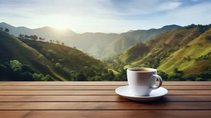 Poster Hot coffee in a white coffee cup on a wooden table a backdrop of high mountain views in the morning. © inthasone