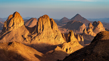 Hoggar landscape in the Sahara desert, Algeria. A view of the mountains and basalt organs that stand around the dirt road that leads to Assekrem. - 738858589
