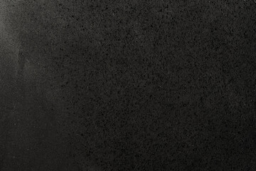 top shot detail photo of rubbery dark foam surface, rubber texture.