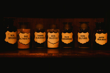 Multiple pharmaceutical liquids on a shelf in an old pharmacy basement - 738862987