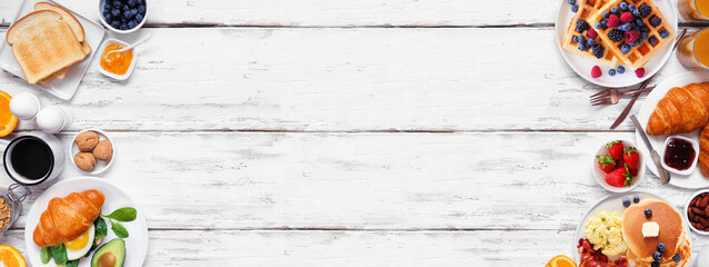 Breakfast or brunch double border on a white wood banner background. Above view. Collection of...