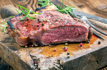 Traditional dry aged barbecue wagyu porterhouse beef steak sliced with herbs and salt served as...