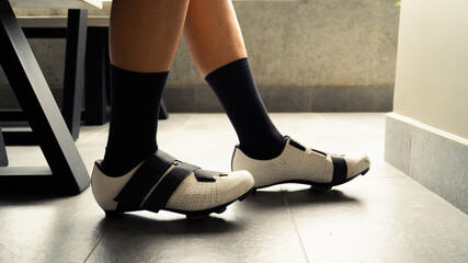 Male wearing his cycling shoes and preparing to go out for training in the mountains of Medellin, Colombia