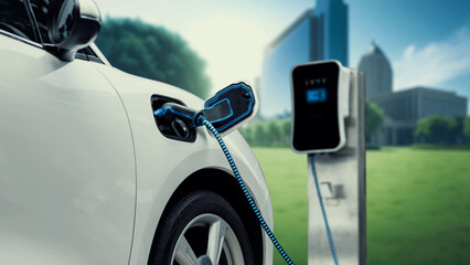 Electric car plug in with charging station to recharge battery with electricity by EV charger cable...
