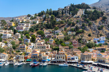 View of harbor town Symi island from high point. Greek mountainous island and municipality, part of Dodecanese island chain. Adjacent upper town Ano Symi