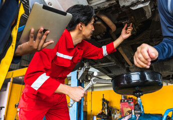 Fototapeta na wymiar Japanese mechanic man fixing car in auto repair garage
