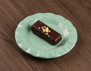 Chocolate brownie on a green plate