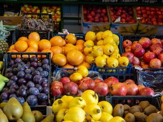 Fruits at the eastern market. Fruits in boxes for sale. The atmosphere of an oriental bazaar