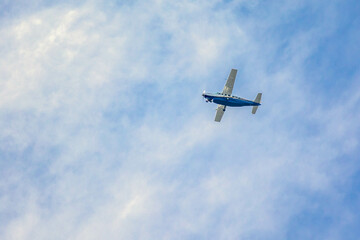 Small plane. A single engine plane crosses the blue sky. Transportation.