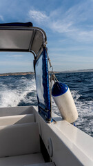 vertical photo of the view from a boat sailing on the waves. View from deck