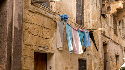 Laundry hanging on a line in front of a building in an old European town
