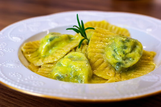 Serving Homemade Pasta Ravioli with Cow Butter Sauce