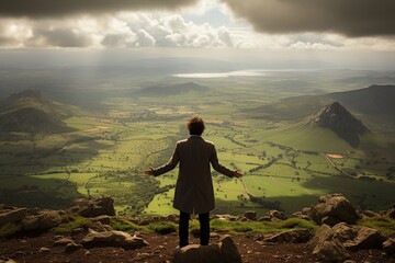 Man on mountaintop with outstretched arms, surrounded by nature. Symbolizes freedom, accomplishment, and connection to the natural world. Majestic scene of exploration.